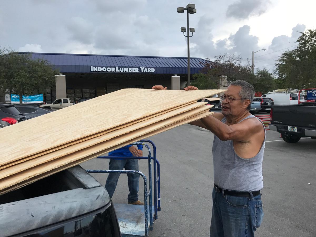 Jerry Garcia, 70, a retired mechanic, loads one of the 20 sheets of plywood he is taking home to prepare for Hurricane Irma at a home supply store in Oakland Park, Florida on Sept. 5, 2017. (REUTERS/Bernie Woodall)