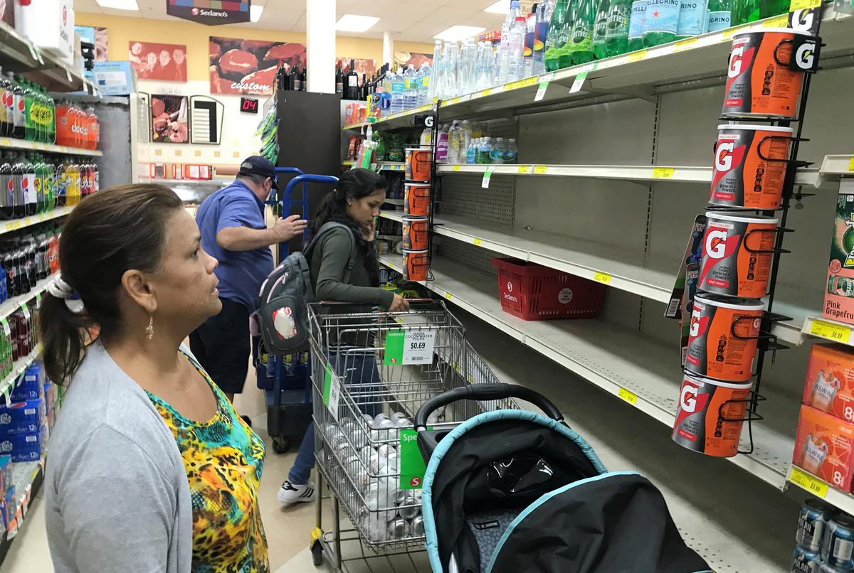 A shopper in Sedano's Supermarket looks at nearly empty water shelves in the Little Havana neighborhood in Miami, Florida on Sept. 5, 2017. (REUTERS/Joe Skipper)