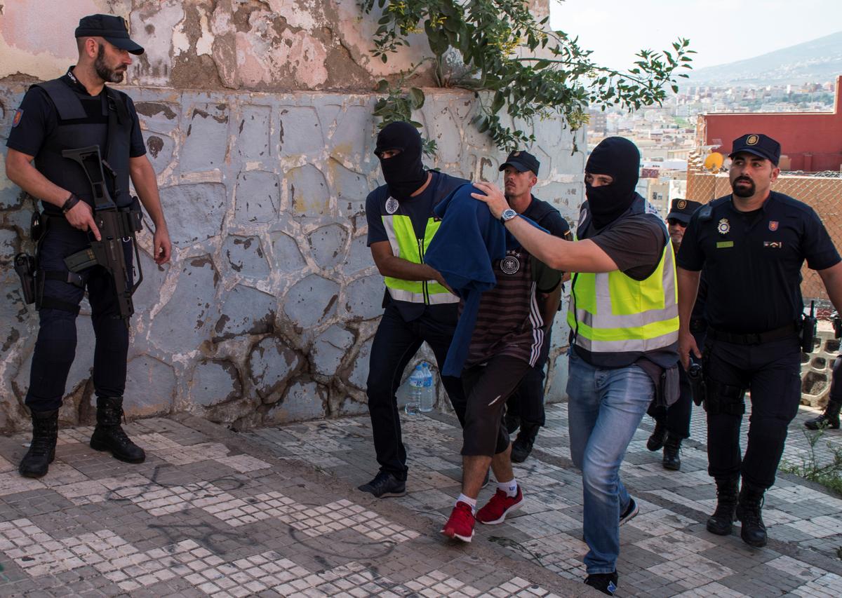 Spanish police arrest a man suspected of belonging to an Islamist terrorist cell that simulated decapitations in the Spanish north African enclave of Melilla on Sept. 6, 2017. (REUTERS/Jesus Blasco de Avellaneda)