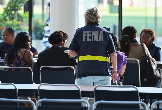  Federal Emergency Management Agency (FEMA) officials help people with questions at the George R. Brown Convention Center, in Houston on September 2, 2017. (Mandel Ngan/AFP/Getty Images)