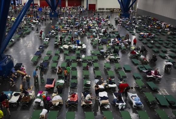 Evacuees fill up cots at the George Brown Convention Center run by the American Red Cross to house displaced victims of Hurricane Harvey on Aug. 28, 2017, in Houston, Texas. (Erich Schlegel/Getty Images)