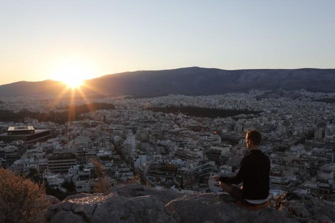 A man meditates on the Pnyx hill in Athens on Sept. 7, 2017. (LUDOVIC MARIN/AFP/Getty Images)