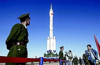 Military soldiers stand guard near the Shenzhou VI spacecraft at the Jiuquan Satellite Launch Center in Ejin, Inner Mongolia, on Oct. 7, 2005. (CHINA PHOTOS/GETTY IMAGES)