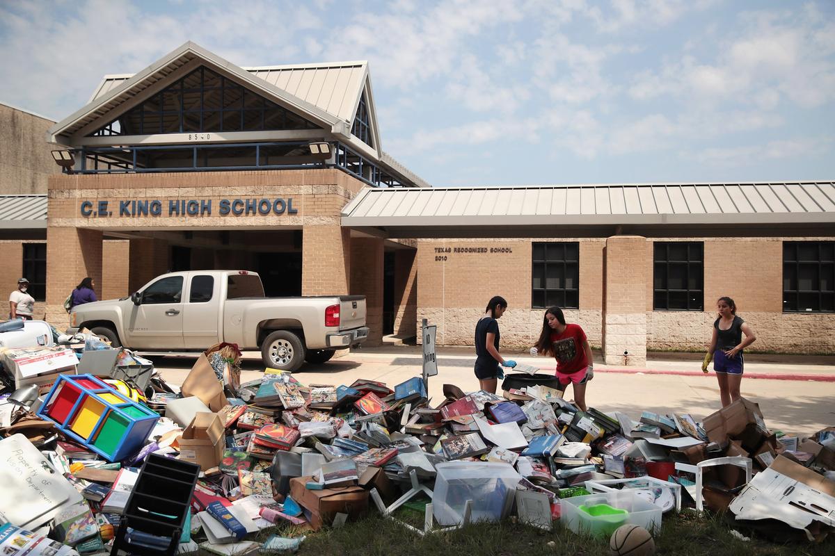 Volunteers and students from C.E. King High School help to clean up the school after torrential rains caused widespread flooding in the area during Hurricane and Tropical Storm Harvey in Houston, Texas on Sept. 1, 2017.(Scott Olson/Getty Images)