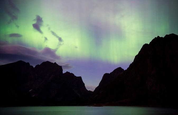 The Northern lights (aurora borealis) illuminate the sky over Reinfjorden in Reine, on Lofoten Islands, Arctic Circle, on Sept. 8. The sun released two powerful solar flares On Sept. 6, which will create brighter auroras extending to as low as Upstate New York for the next few nights. (JONATHAN NACKSTRAND/AFP/Getty Images)