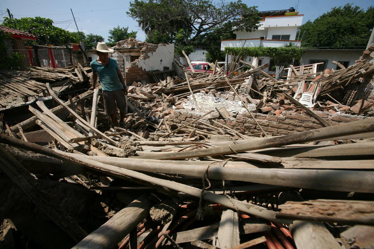 A man stands amidst the remains of a house after an earthquake struck the southern coast of Mexico in Union Hidalgo, Mexico on Sept. 9, 2017. (REUTERS/Jorge Luis Plata)