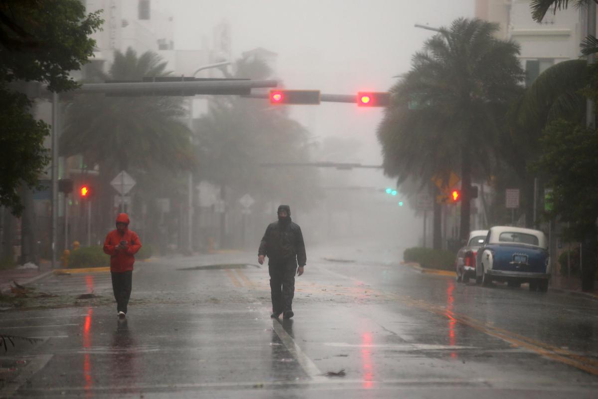 People walk along a street in South Beach as Hurricane Irma arrives at south Florida, in Miami Beach, Florida on Sept. 10, 2017. (REUTERS/Carlos Barria)