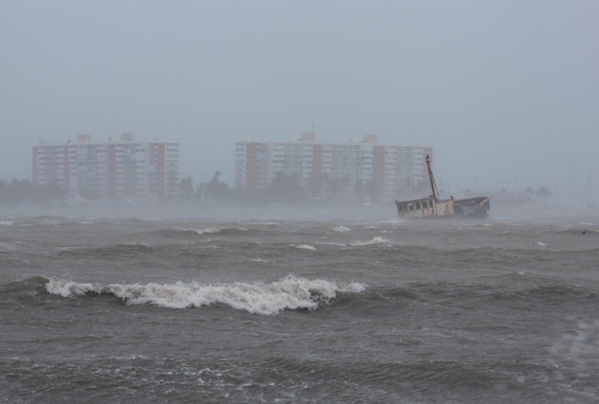 Waves battle a stranded ship in Fajardo, Puerto Rico. (REUTERS/Alvin Baez)