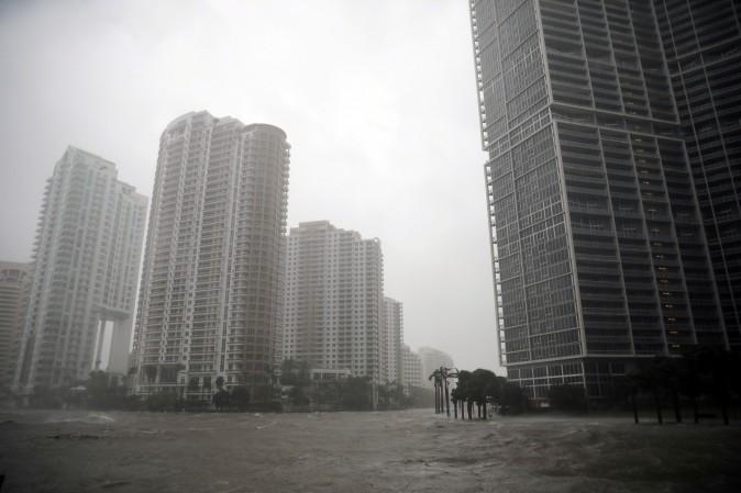 Water rises from the Miami River onto the streets as Hurricane Irma arrives in Miami, Fla., on Sept. 10, 2017. (REUTERS/Carlos Barria)