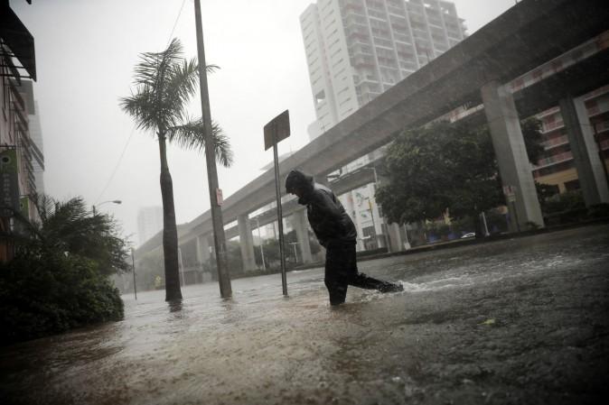 A local resident walks across a flooded street in downtown Miami as Hurricane Irma arrives in South Florida on Sept. 10, 2017. (Reuters/Carlos Barria)
