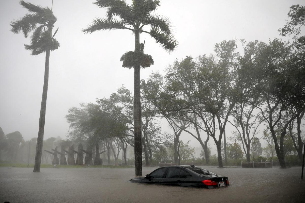 A partially submerged car is seen at a flooded area in Coconut Grove as Hurricane Irma arrives at south Florida, in Miami, Florida on Sept. 10, 2017. (REUTERS/Carlos Barria)