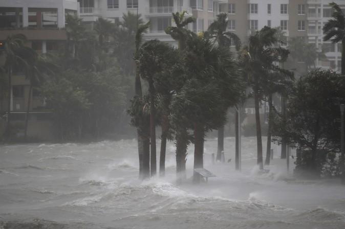 MIAMI, FL - SEPTEMBER 10: Water flows out of the Miami River to flood a walkway as Hurricane Irma passes through on September 10, 2017 in Miami, Florida. Hurricane Irma made landfall in the Florida Keys as a Category 4 storm on Sunday, lashing the state with 130 mph winds as it moves up the coast. (Joe Raedle/Getty Images)