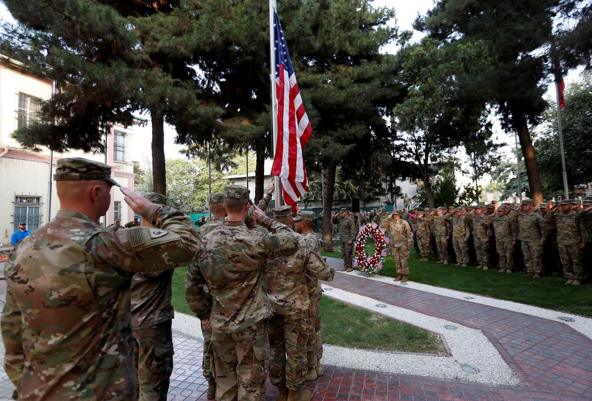 U.S. soldiers prepare to raise the American flag during a memorial ceremony to commemorate the 16th anniversary of the 9/11 attacks, in Kabul, Afghanistan on Sept. 11, 2017. (REUTERS/Mohammad Ismail)