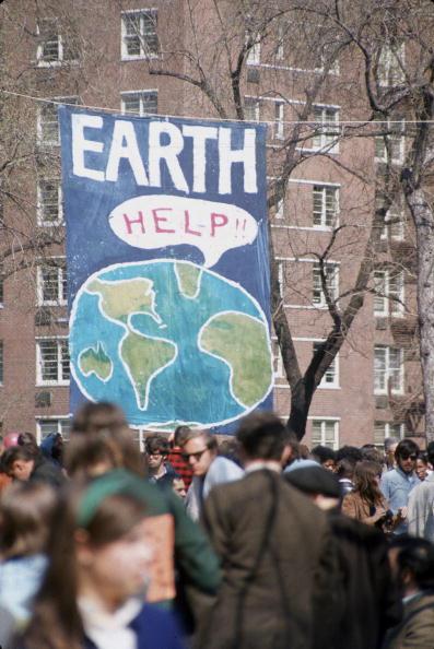 People gather near a large poster that shows a speech bubble from planet Earth that reads 'Help!!', on the occasion of the first Earth Day conservation awareness celebration, New York City, on April 22, 1970. (Hulton Archive/Getty Images)