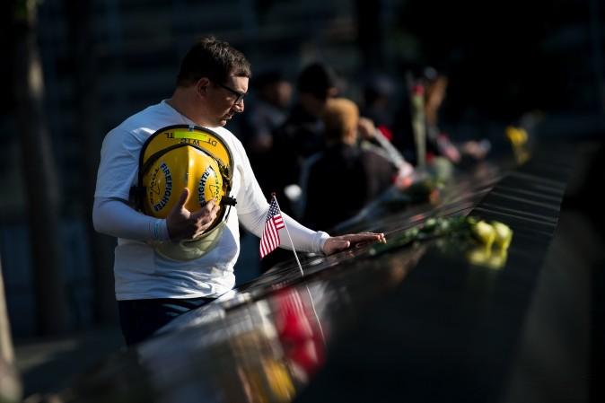 James Taormina, whose brother Dennis was killed in the 9/11 attacks, pauses at the memorial before a commemoration ceremony for the victims of the September 11 terrorist attacks at the National September 11 Memorial, in New York City on Sept. 11. (Drew Angerer/Getty Images)