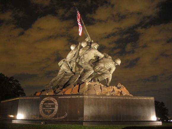 The United States Marine Corps War Memorial by Felix de Weldon of the Iwo Jima soldiers stands out clearly against the night sky in the Rosslyn area of Arlington, Virginia. (Public domain/Catie Drew)