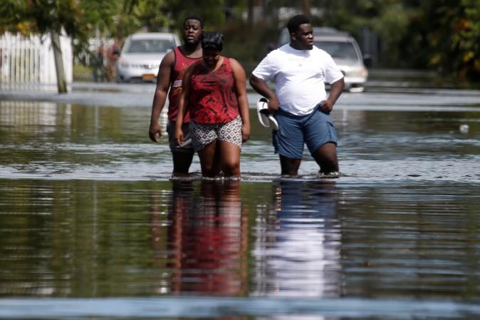 People walk on a flooded street following Hurricane Irma in North Miami, Florida on Sept. 11, 2017. (Reuters/Carlo Allegri)