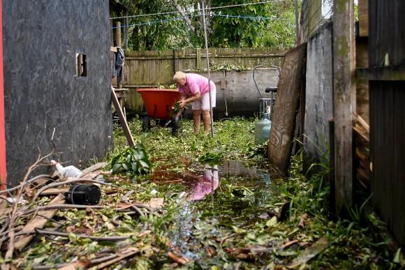 Joan Markel, cleaning debris from her yard, after Hurricane Irma hit Jerome, Fla., on Sept. 12, 2017. (Reuters/Bryan Woolston)