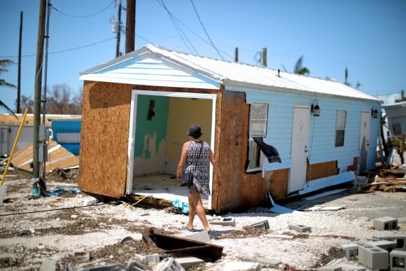 Lora Castelo walks by her destroyed trailer home after Hurricane Irma struck Florida, in Islamorada, U.S., September 12, 2017. (Reuters/Carlos Barria)