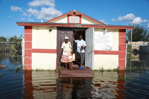 Pastor Louicesse Dorsaint stands with his wife Maria Dorsaint in front of their church, Haitian United Evangelical Mission, which was damaged by flooding from Hurricane Irma in Immokalee, Florida, U.S. September 12, 2017 (Reuters/Stephen Yang)