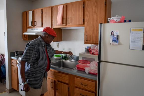 Two days after Hurricane Irma caused a power and water outage, William James, 83, checks the faucet for water, in his room at Cypress Run, an assisted living facility, in Immokalee, Florida, September 12, 2017. REUTERS/Bryan Woolston)