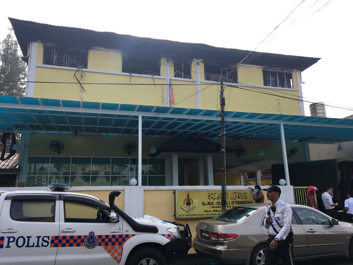 Police and fire department work at the religious school Darul Quran Ittifaqiyah after a fire broke out in Kuala Lumpur, Malaysia on Sept. 14, 2017. (REUTERS/A. Ananthalakshmi)
