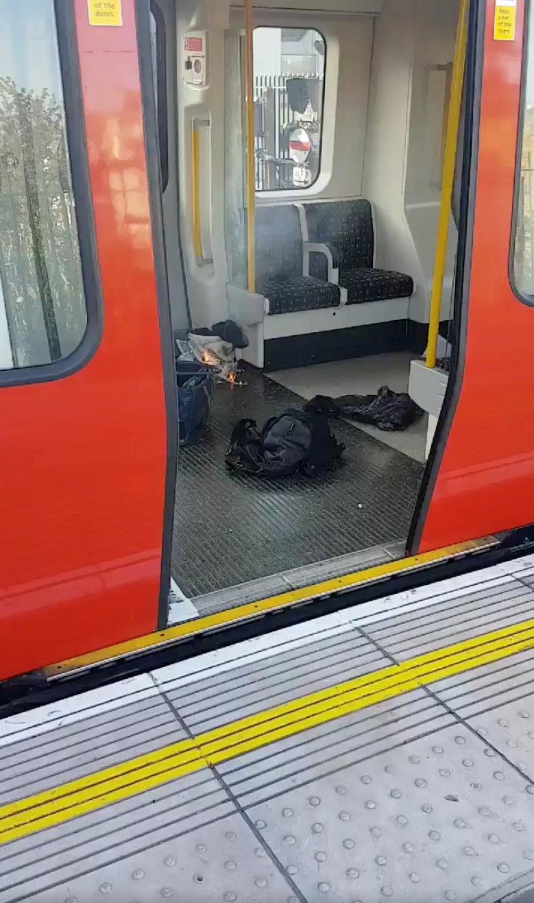 Personal belongings and a bucket with an item on fire inside it, are seen on the floor of an underground train carriage at Parsons Green station in West London, Britain on Sept. 15, 2017, in this image taken from social media. (SYLVAIN PENNEC/via REUTERS)