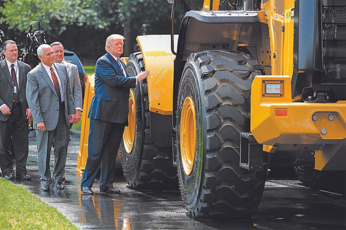President Donald Trump views a wheel loader made by Caterpillar while touring a Made in America product showcase with Vice President Mike Pence on the South Lawn of the White House on July 17. (CHIP SOMODEVILLA/GETTY IMAGES)