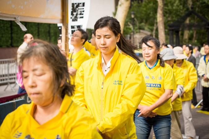 Falun Gong practitioners exercise at the Dag Hammarskjold Plaza near the United Nations headquarters in New York on Sept. 19, 2017, to raise awareness about the persecution inside China that is now in its 18th year. (Benjamin Chasteen/The Epoch Times)