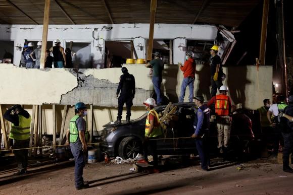Rescue workers search through rubble in a floodlit search for students at Enrique Rebsamen school in Mexico City on Sept. 19, 2017. (Carlos Jasso/Reuters)