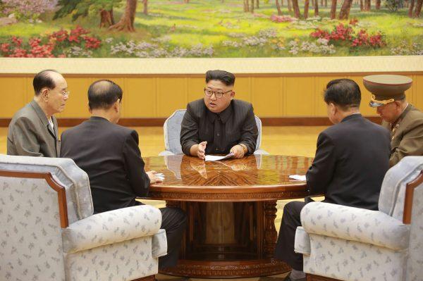 North Korean dictator Kim Jong-Un (C) talks to other communist officials at an undisclosed location in North Korea in this picture released by North Korea's official Korean Central News Agency. (STR/AFP/Getty Images)