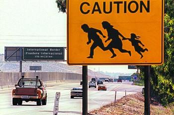 A sign warning drivers about illegal immigrants running across the highway near the U.S.–Mexico border in San Diego on Aug. 9, 1997. (HECTOR MATA/AFP/GETTY IMAGES)