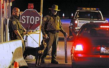 Border Patrol agents prepare to question a motorist at a checkpoint along Highway 94 near Campo, Calif., on Oct. 17, 2007. (SANDY HUFFAKER/GETTY IMAGES)