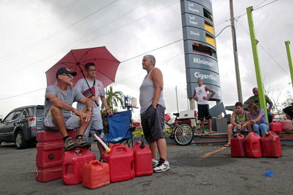 People wait at a gas station to fill up their fuel containers, in the aftermath of Hurricane Maria, in San Juan, Puerto Rico on September 27, 2017. (REUTERS/Alvin Baez)