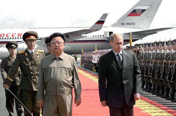 Russian President Vladimir Putin (R) is welcomed by the leader of Democratic People's Republic of Korea Kim Jong Il (L) upon Putin's arrival in Pyongyang's airport, 19 July, 2000. (ITAR-TASS/AFP/Getty Images)