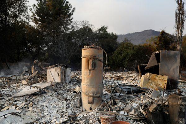 A water heater stands amidst remains of a home destroyed by the Nuns Fire along Napa Road in Sonoma, California, U.S., Oct. 9, 2017. (Reuters/Stephen Lam)