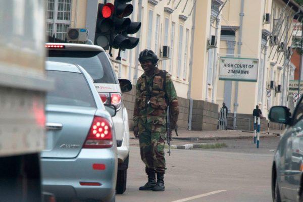 A Zimbabwean soldier stands by an intersection as they regulate civilian traffic in front of the High Court of Zimbabwe in Harare on Nov. 15, 2017. (Wilfred Kajese/AFP/Getty Images)
