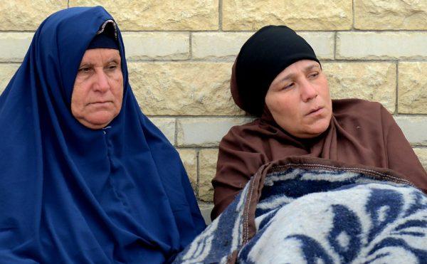 Relatives of the victims of the bomb and gun assault on the North Sinai Rawda mosque sit outside the Suez Canal University hospital in the eastern port city of Ismailia on November 25, 2017, where they were taken to receive treatment following the deadly attack the day before. (Mohamed El-Shahed /AFP/Getty Images)