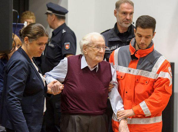 Oskar Gröening (C), 94, a former member of the Waffen-SS who worked at the Auschwitz concentration camp during World War II, is helped into court by lawyer Susanne Frangenberg (L) on July 15, 2015, in Lüneburg, Germany. (Hans-Jurgen Weg/ Pool/Getty Images)