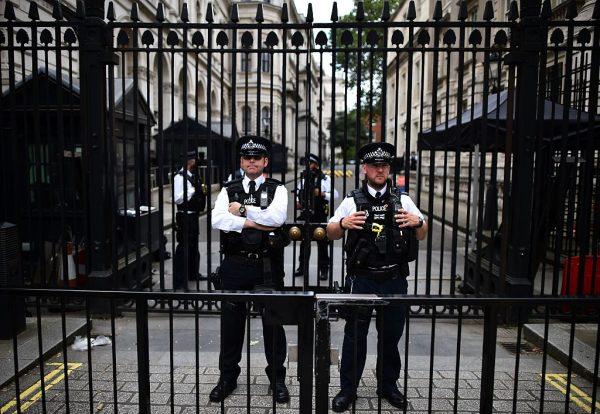 British Police officers stand on duty on Whitehall, outside the gated entrance to Downing Street, the official residence of the British Prime Minister June 28, 2016. Damian Green became involved in an incident with officers at the gate in 2008 after one challenged him over using the wrong entrance, leading to a complicated series of events culminating in an inquiry into leaks to the press. (Ben Stansall/AFP/Getty Images)
