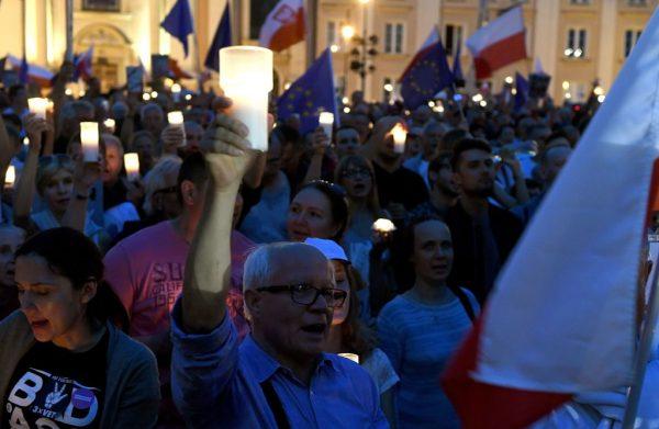 A man holds a candle as protesters take part in a demonstration in front of the Polish Supreme Court on July 23, 2017, in Warsaw to protest against the new bill changing the judiciary system. (Janek Skarzynski/AFP/Getty Images)