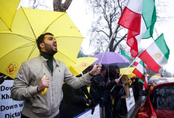 Opponents of Iranian President Hassan Rouhani hold a protest outside the Iranian embassy in west London, on Dec. 31, 2017. (REUTERS/Eddie Keogh)