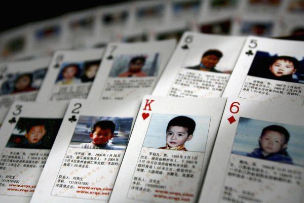 Playing cards showing details of missing children are displayed in 2007 in Beijing, China. The cards, showing photographs and information of 27 missing children, were created by Shen Hao, the founder of a missing persons website, and are to be handed out in areas notorious for child trafficking. China has just been put on a list of countries of serious concern for human trafficking. (China Photos/Getty Images)