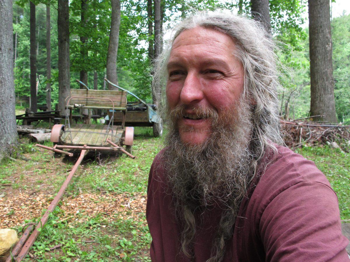 Eustace Conway sits near horse-drawn farm implements at his Turtle Island Preserve in Triplett, N.C., on June 27, 2013. People come from all over the world to learn natural living and how to go off-grid, but local officials ordered the place closed over health and safety concerns. (Allen Breed/AP Photo)