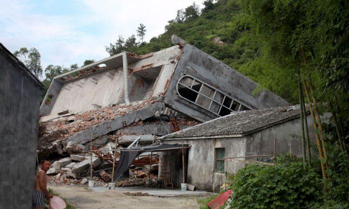 A man stands near the razed remains of a Catholic church in a village in Pingyang county of Wenzhou in eastern China's Zhejiang Province on July 16, 2014. (Didi Tang/AP Photo)