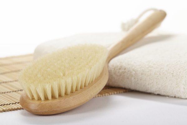 Use a brush with natural bristles for skin brushing, and be sure both the brush and your skin are dry. (schulzhattingen/iStock)