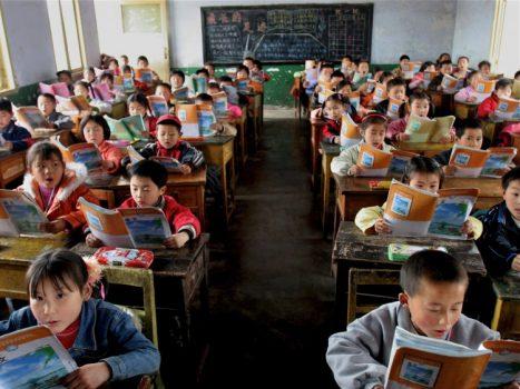 An elementary school class reads the standardized textbooks for learning Chinese in Sichuan Province, China, on April 8, 2005. (China Photos/Getty Images)