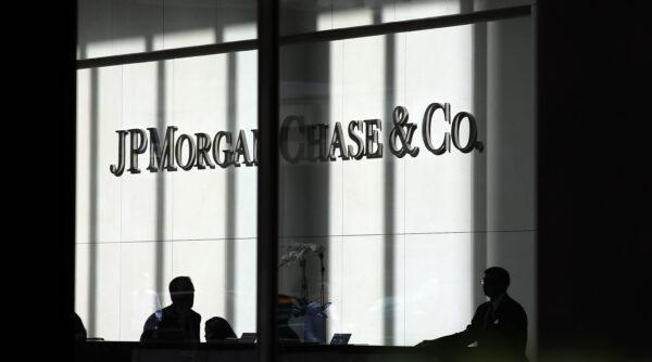 People pass a sign for JPMorgan Chase & Co. at its headquarters in New York on Oct. 2, 2012. (Spencer Platt/Getty Images)