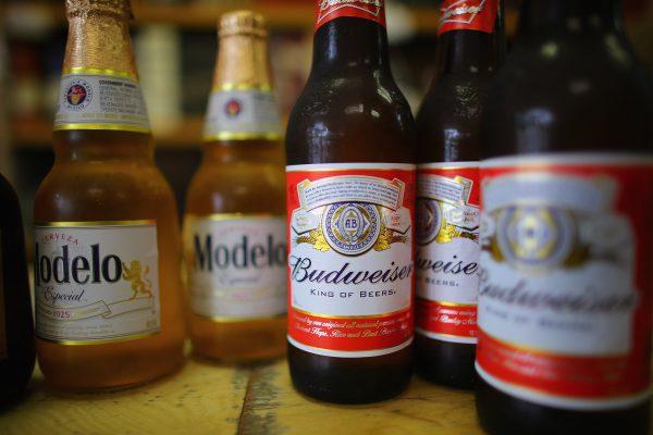 Bottles of Anheuser-Busch Budweiser and Grupo Modelo, Modelo beers are displayed at the Chandi Wines and Spirits store in Miami, Florida, on January 31, 2013. (Photo Illustration by Joe Raedle/Getty Images)