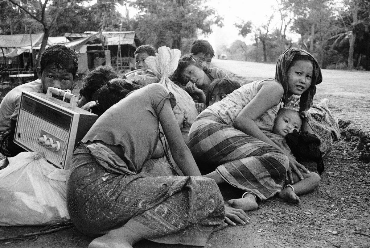 Cambodian women and children huddle close together in fear of incoming fire from Khmer Rouge forces of Highway 5, just northwest of Phnom Penh, April 6, 1975. (AP Photo)